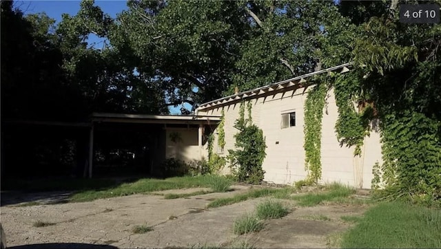 view of side of property with a carport