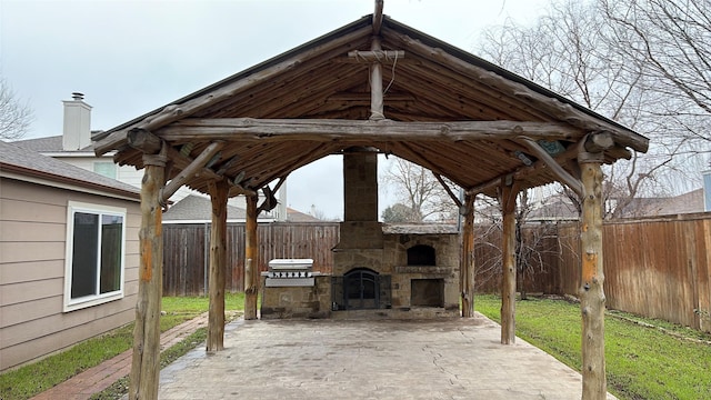 view of patio featuring grilling area and an outdoor stone fireplace