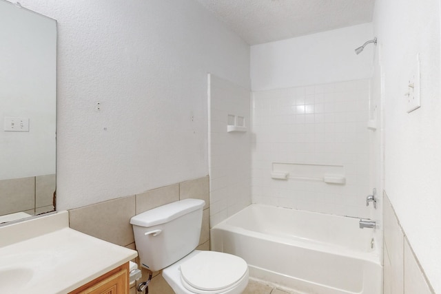 bathroom with  shower combination, vanity, toilet, and a textured ceiling