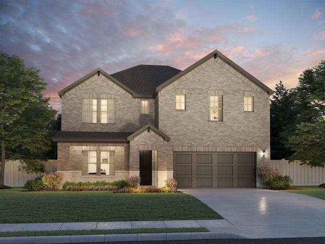 view of front of house with a garage and a yard