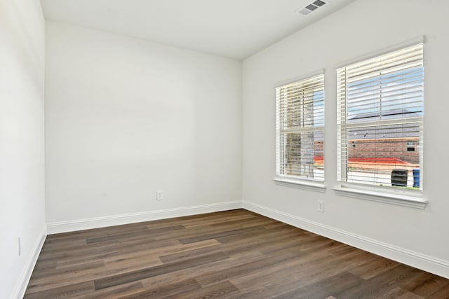 2321 Wellington Ln, Corinth, TX 76210 - unfurnished room with dark wood-type flooring and baseboards