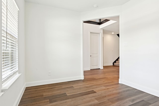 2321 Wellington Ln, Corinth, TX 76210 - spare room with wood finished floors, stairs, baseboards, and a smoke detector