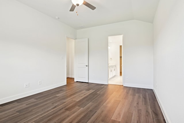 2321 Wellington Ln, Corinth, TX 76210 - unfurnished bedroom featuring dark wood-type flooring, ensuite bathroom, baseboards, vaulted ceiling, and ceiling fan