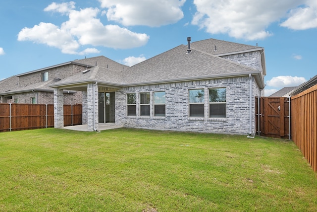 2321 Wellington Ln, Corinth, TX 76210 - rear view of property featuring a patio area, roof with shingles, brick siding, and a gate