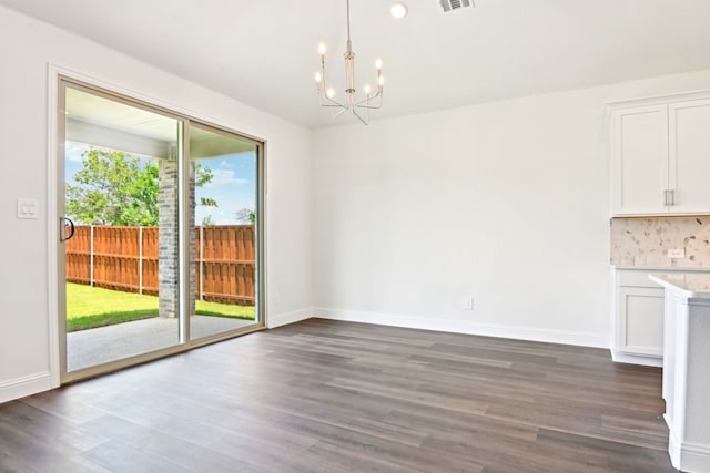 2321 Wellington Ln, Corinth, TX 76210 - unfurnished dining area featuring a chandelier, dark wood-style floors, and baseboards