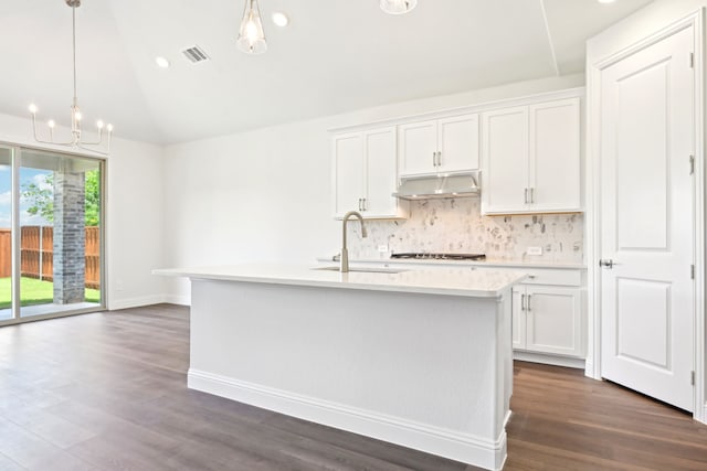2321 Wellington Ln, Corinth, TX 76210 - kitchen featuring a sink, under cabinet range hood, light countertops, tasteful backsplash, and vaulted ceiling
