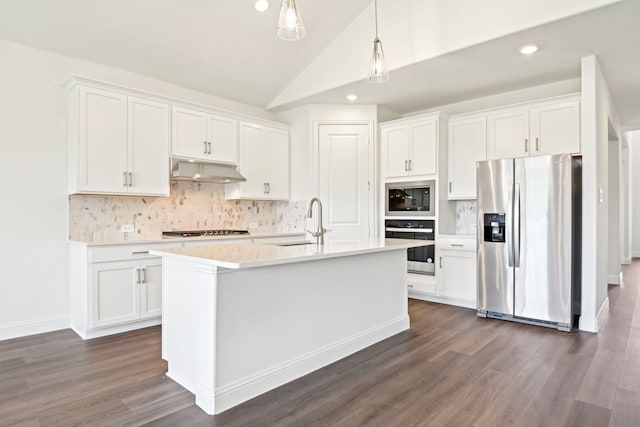 2321 Wellington Ln, Corinth, TX 76210 - kitchen with stainless steel appliances, a sink, under cabinet range hood, white cabinetry, and light countertops