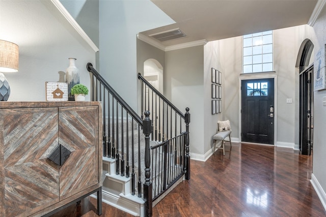 entryway featuring a high ceiling, crown molding, and dark hardwood / wood-style floors