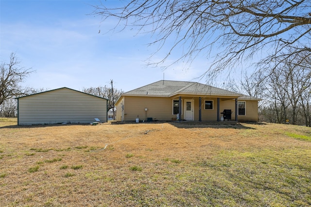 back of property featuring covered porch and a yard