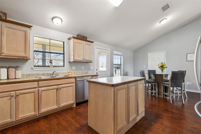 kitchen with light brown cabinets, a sink, visible vents, stainless steel dishwasher, and plenty of natural light