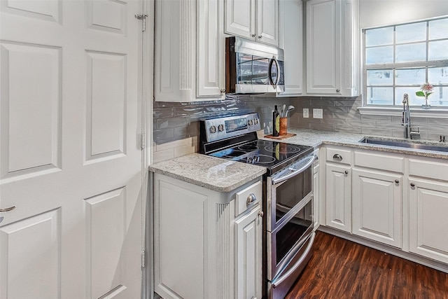 kitchen featuring sink, appliances with stainless steel finishes, and white cabinets