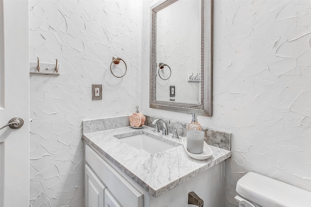 bathroom featuring toilet and vanity