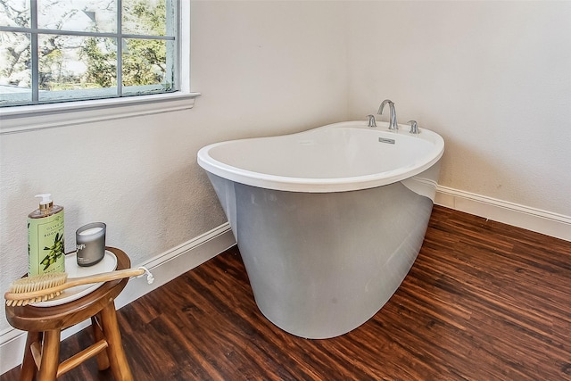 bathroom featuring wood-type flooring and a bathing tub