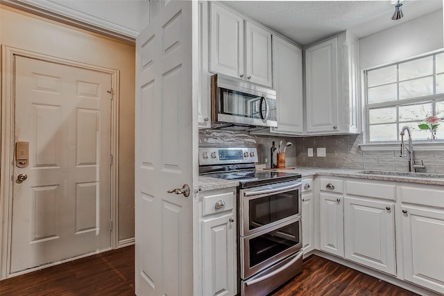 kitchen featuring sink, appliances with stainless steel finishes, and white cabinets