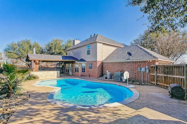 view of swimming pool with central AC unit and a patio