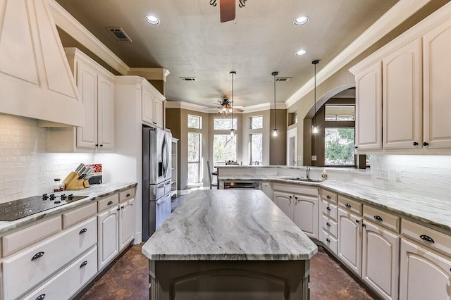 kitchen with sink, kitchen peninsula, a kitchen island, and premium range hood