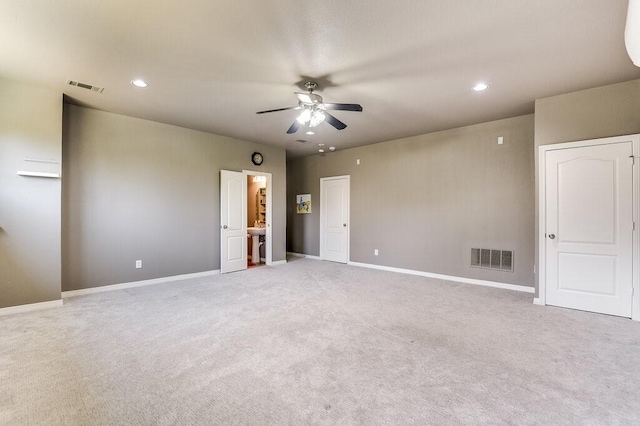 carpeted spare room featuring ceiling fan