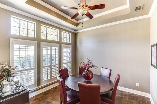 dining space with crown molding, a tray ceiling, a baseboard radiator, and ceiling fan