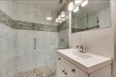 bathroom with an enclosed shower and vanity