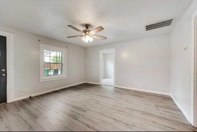 spare room with light hardwood / wood-style flooring and ceiling fan