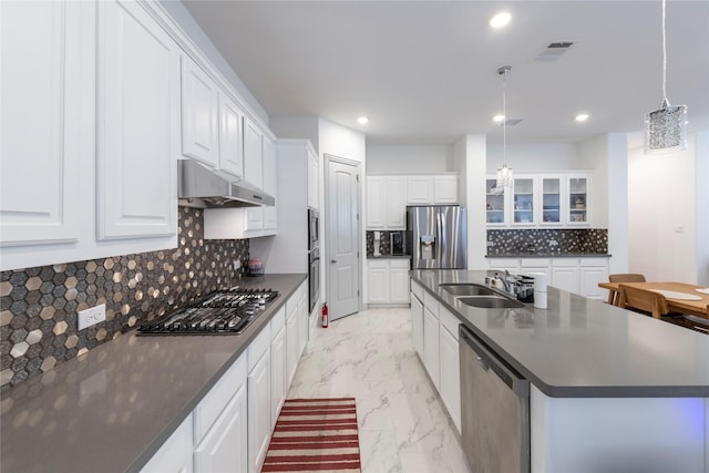 kitchen featuring hanging light fixtures, white cabinetry, stainless steel appliances, and sink