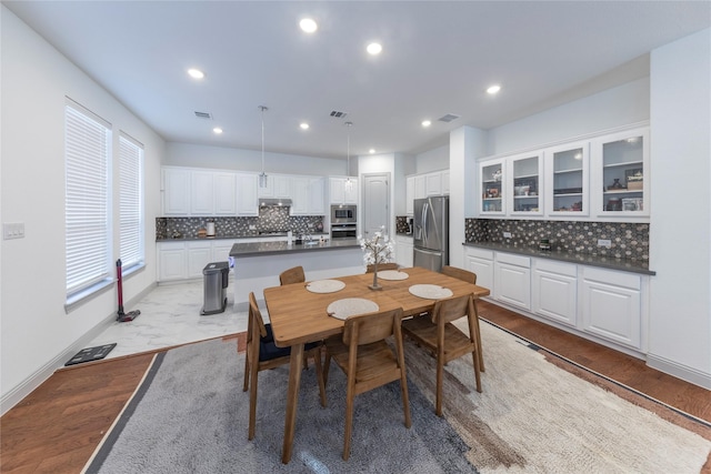 dining space with light wood-type flooring