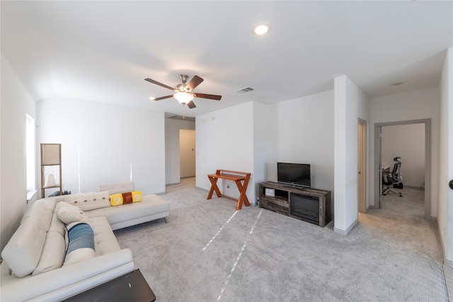 carpeted living room with ceiling fan