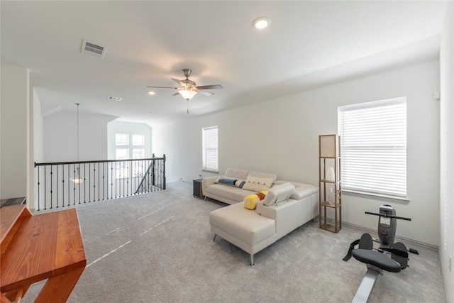 living room featuring ceiling fan, light carpet, and lofted ceiling