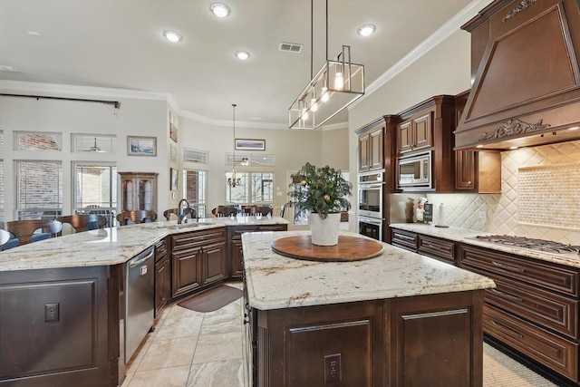 kitchen featuring custom exhaust hood, open floor plan, appliances with stainless steel finishes, recessed lighting, and a spacious island
