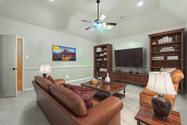 living room with visible vents, baseboards, ceiling fan, vaulted ceiling, and light colored carpet