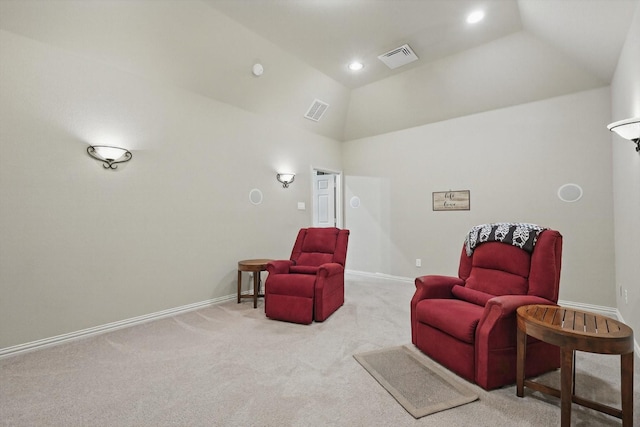 sitting room featuring visible vents, baseboards, carpet flooring, and lofted ceiling
