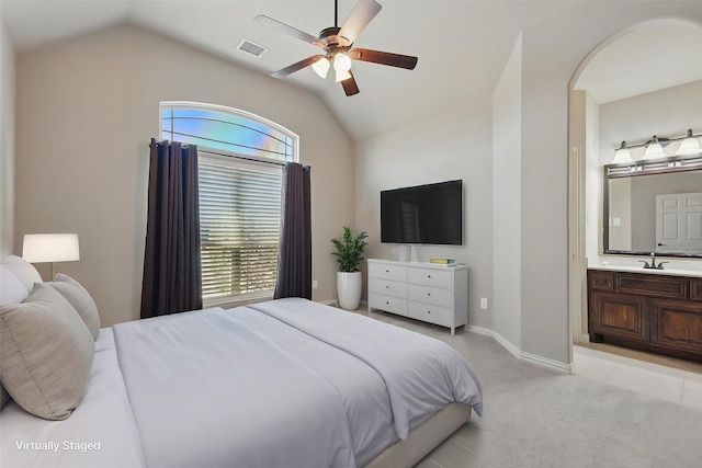bedroom featuring light carpet, ensuite bath, visible vents, and vaulted ceiling