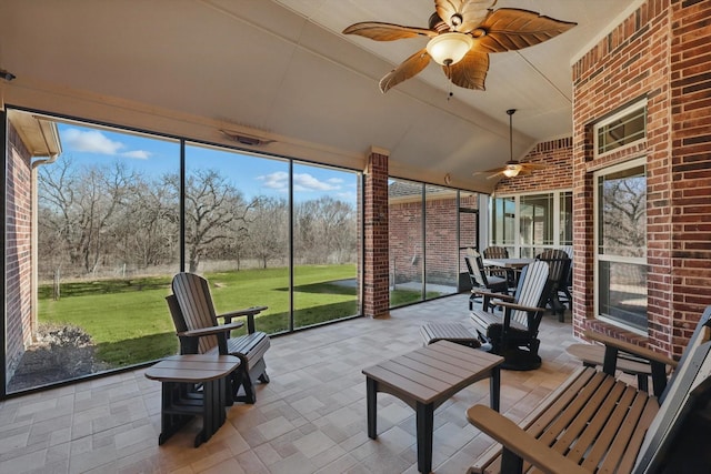 sunroom featuring a ceiling fan
