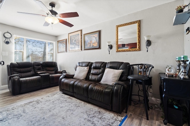 living room with ceiling fan and wood-type flooring