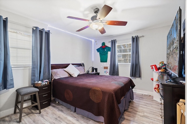 bedroom with light wood-type flooring and ceiling fan