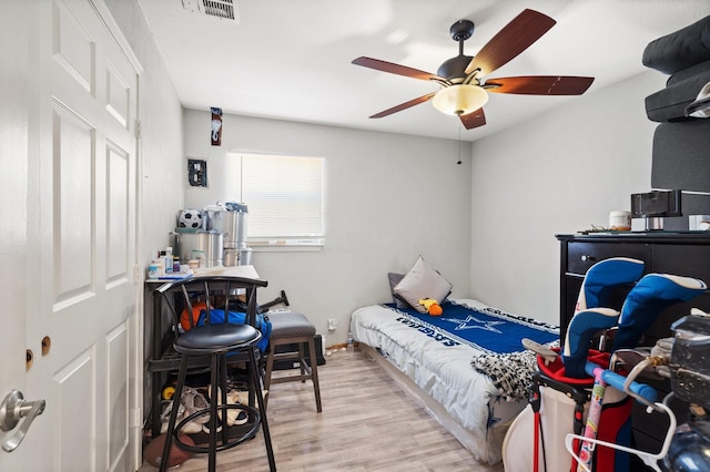 bedroom with ceiling fan and light hardwood / wood-style floors