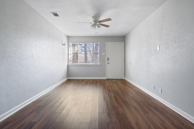 unfurnished room featuring dark hardwood / wood-style flooring and ceiling fan