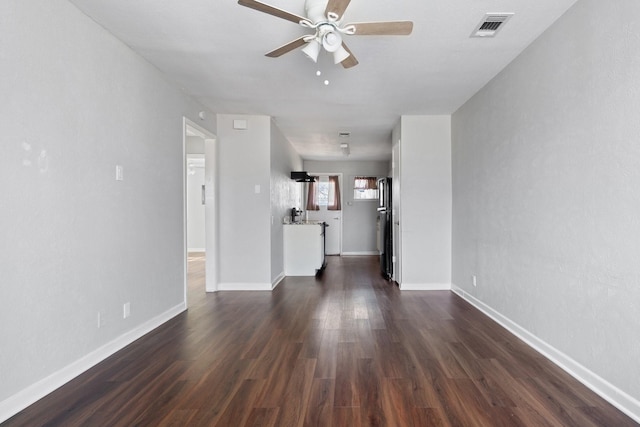 unfurnished living room with dark wood-type flooring and ceiling fan