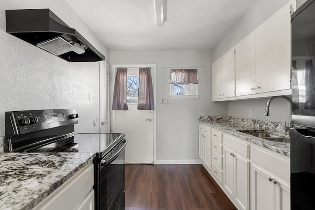 kitchen featuring light stone countertops, ventilation hood, black electric range, sink, and white cabinetry