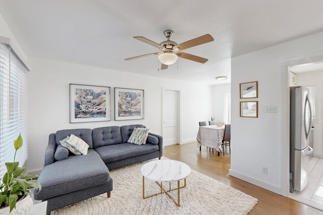 living room with hardwood / wood-style floors and ceiling fan