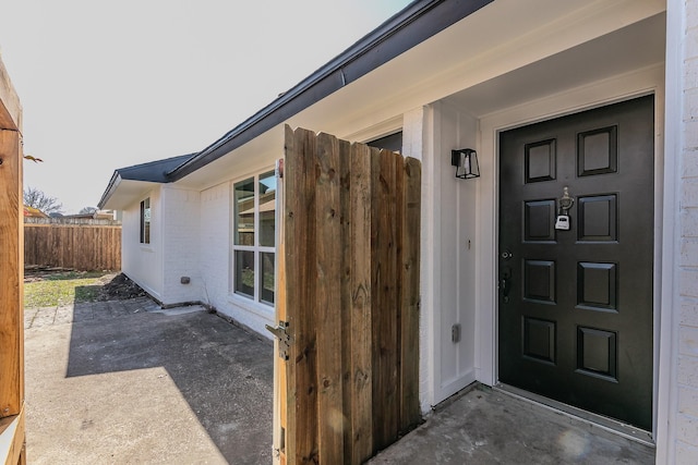 entrance to property featuring a patio