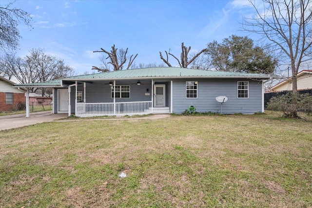 single story home featuring a porch, an attached carport, metal roof, and a front yard