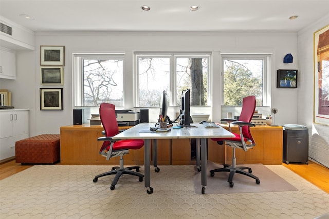 office space featuring ornamental molding and light hardwood / wood-style flooring