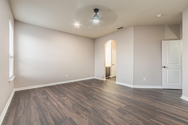 unfurnished room featuring ceiling fan and dark wood-type flooring