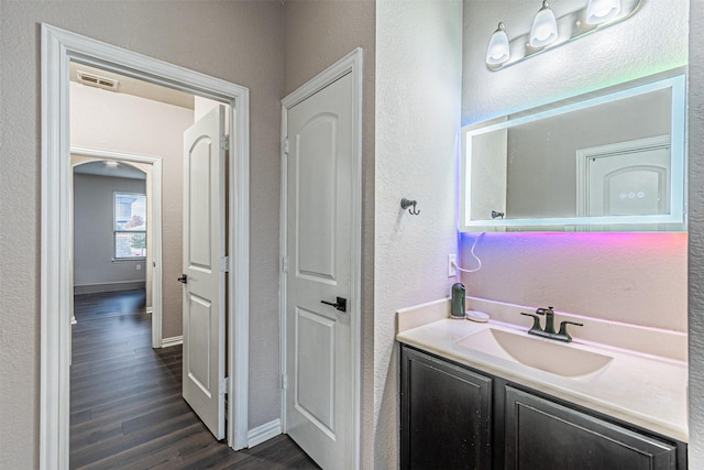 bathroom featuring hardwood / wood-style flooring and vanity