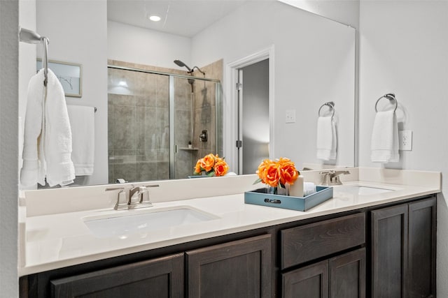 bathroom featuring vanity and a shower with door