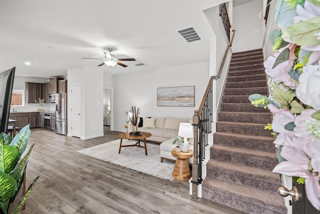 living room with hardwood / wood-style flooring and ceiling fan