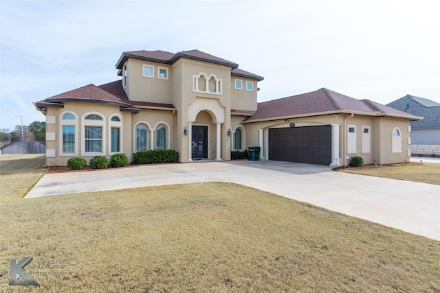 mediterranean / spanish-style home with a front yard and a garage