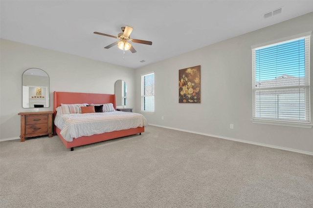 bedroom featuring ceiling fan, carpet floors, visible vents, and baseboards