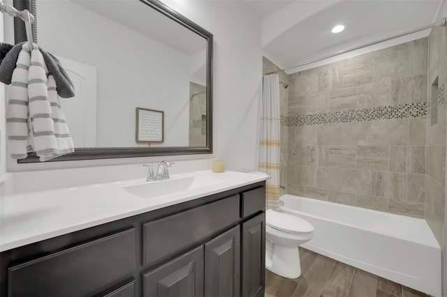 bathroom featuring toilet, shower / tub combo with curtain, wood finished floors, and vanity